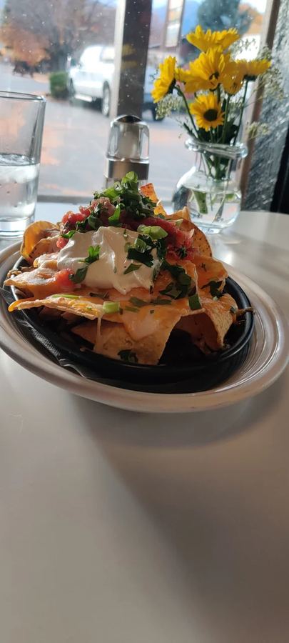 Loaded nachos at a window table